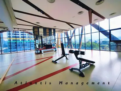a gym with exercise equipment in a building with windows at Parc 3, Taman Pertama, Kuala Lumpur By Atlantis Management in Kuala Lumpur