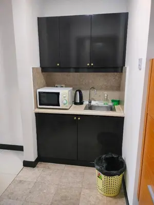 a kitchen with a sink and a microwave at Snowfall suite at berjaya Times Square in Kuala Lumpur