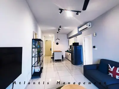 a living room with a blue couch and a kitchen at Parc 3, Sunway Velocity in Kuala Lumpur