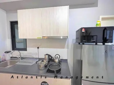 a kitchen with a sink and a refrigerator at Parc 3, Sunway Velocity in Kuala Lumpur