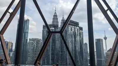 a view of the kuala lumpur city skyline from a bridge at Scarletz Suites KLCC by IH in Kuala Lumpur