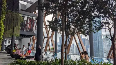 a group of people sitting in a pool in a building at Scarletz Suites KLCC by IH in Kuala Lumpur
