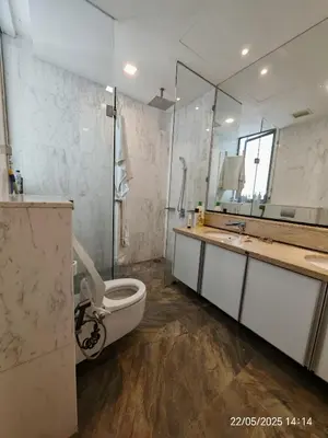 a bathroom with a toilet and a sink and a mirror at Icon Residence in Kuala Lumpur