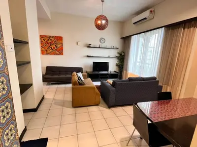a living room with two couches and a tv at Seri Bukit Ceylon Bukit Bintang in Kuala Lumpur