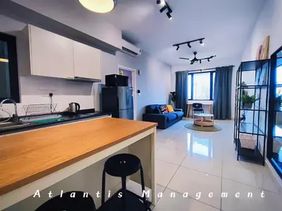 a kitchen and living room with a counter top at Parc 3 KL South Cozy Apartment, Walking Distance to AEON Maluri & Sunway Velocity in Kuala Lumpur
