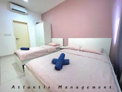 two beds in a room with blue towels on them at Parc 3 KL South Cozy Apartment, Walking Distance to AEON Maluri & Sunway Velocity in Kuala Lumpur