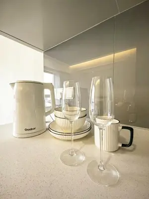 two wine glasses sitting on top of a counter at TRX Agile Bukit Bintang Deluxe 8 pax Family Suites in Kuala Lumpur