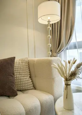 a living room with a couch and a lamp at TRX Agile Bukit Bintang Deluxe 8 pax Family Suites in Kuala Lumpur