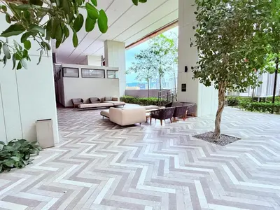 a lobby with a tree in the middle of a building at Lucentia Residences BBCC LaLaport in Kuala Lumpur