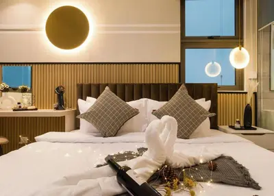 a bedroom with a bed with a bunch of items on it at Lucentia Residences BBCC LaLaport in Kuala Lumpur