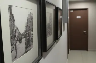 a row of pictures hanging on a wall at Hotel 1000 Miles in Kuala Lumpur