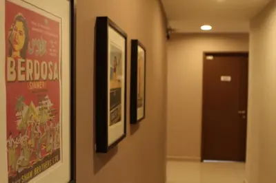 a hallway with three framed posters on a wall at Hotel 1000 Miles in Kuala Lumpur