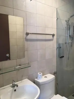a bathroom with a toilet and a sink and a mirror at Hotel 1000 Miles in Kuala Lumpur