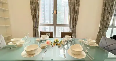 a dining room table with white dishes and glasses at Kuala Lumpur Digital Work Base in Kuala Lumpur
