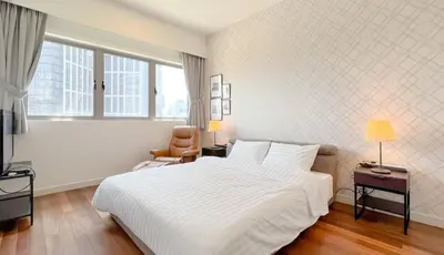 a bedroom with a large white bed and a window at Kuala Lumpur Digital Work Base in Kuala Lumpur