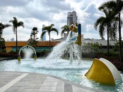 a water park with a boy jumping off a slide at TrionKL Luxury Stay 2BR Free Wi-Fi 10min to KLCC - Chinese Host in Kuala Lumpur