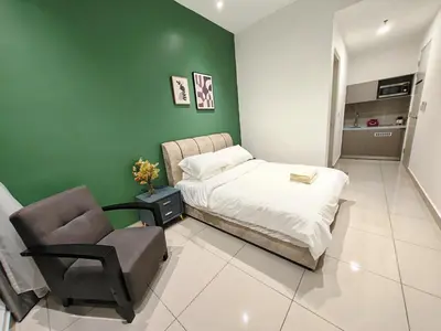 a bedroom with a bed and a chair at TrionKL Luxury Stay 2BR Free Wi-Fi 10min to KLCC - Chinese Host in Kuala Lumpur