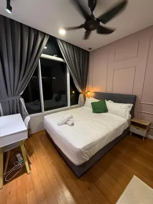 a bedroom with a bed with a ceiling fan at Dawn Getaways in Kuala Lumpur