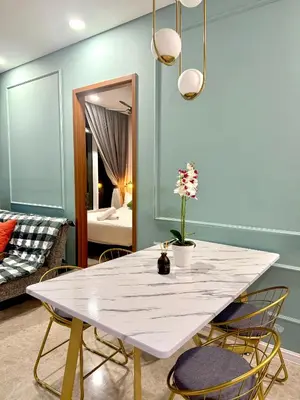 a dining room with a white table and chairs at Dawn Getaways in Kuala Lumpur