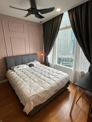 a bedroom with a bed with a ceiling fan and a window at Dawn Getaways in Kuala Lumpur