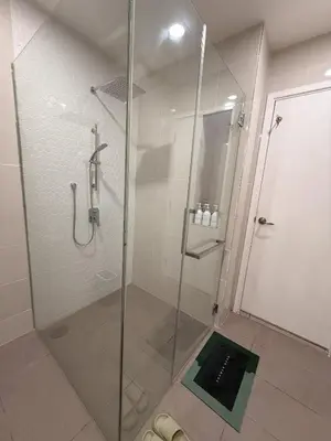 a bathroom with a shower with a glass door at Continew Residence Studio Apartment in Kuala Lumpur