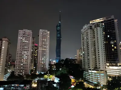 a city skyline with tall buildings at night at AK Residence in Kuala Lumpur
