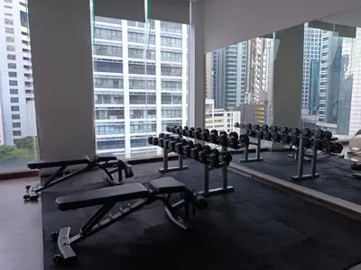 a gym with rows of exercise equipment in a building at AK Residence in Kuala Lumpur