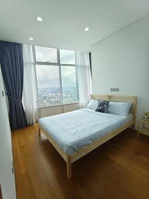 a bed in a room with a large window at Sleep in the Sky KLCC View in Kuala Lumpur
