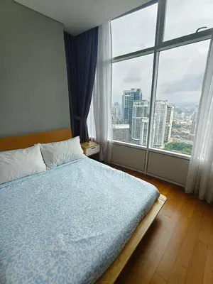 a bedroom with a bed and a large window at Sleep in the Sky KLCC View in Kuala Lumpur