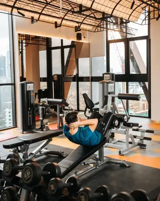 a woman exercising on a treadmill in a gym at Scarletz Luxury Suites KLCC in Kuala Lumpur