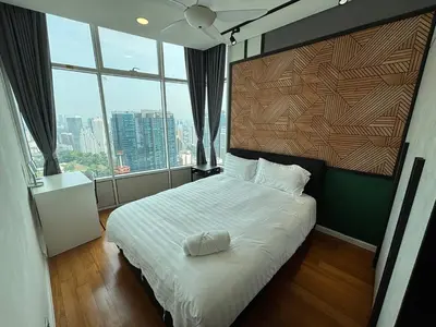 a bedroom with a white bed with a large window at Sky Suites KLCC by Easy Nap in Kuala Lumpur