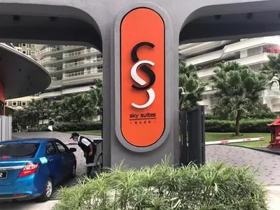 a sign for a ski slope hotel next to a car at Sky Suites KLCC by Easy Nap in Kuala Lumpur