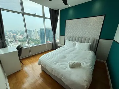 a bedroom with a white bed with a large window at Sky Suites KLCC by Easy Nap in Kuala Lumpur