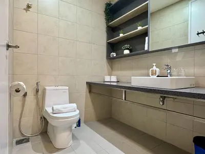 a bathroom with a toilet and a sink at Balcony Cityscape IIII The Robertson Residence 42f in Kuala Lumpur