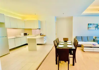 a kitchen and living room with a table and a couch at Swiss Garden Residence by Aspire Suites in Kuala Lumpur