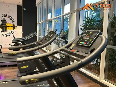 a row of treadmills in a gym at Quill Residence 1R1B with Netflix 23F&Massive Pool in Kuala Lumpur