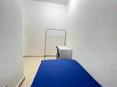 a room with a blue bed in the corner at Male Room at Plaza Rah, KL City Centre in Kuala Lumpur