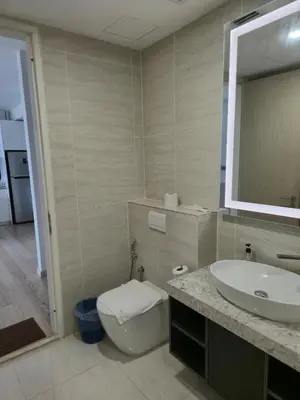 a bathroom with a sink and a toilet and a mirror at Star Residence Sky World KLCC in Kuala Lumpur