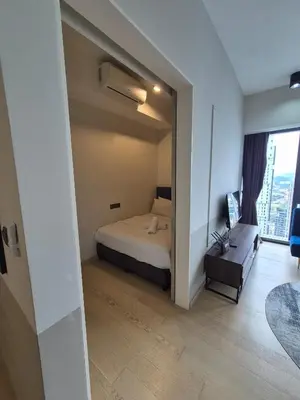 a bedroom with a bed and a large window at Star Residence Sky World KLCC in Kuala Lumpur