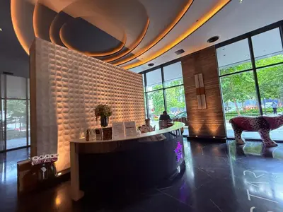 a lobby with a large wall of windows and a table at Star Residence Sky World KLCC in Kuala Lumpur