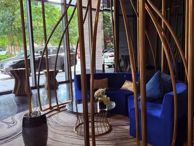 a blue couch in a room with a window at Star Residence Sky World KLCC in Kuala Lumpur