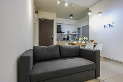 a living room with a couch and a kitchen at Stylish M Vertica 4 Bedroom Walk to MRT Velocity Mall in Kuala Lumpur