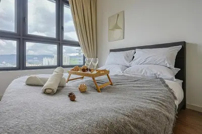 a bedroom with a bed with a table on it at Stylish M Vertica 4 Bedroom Walk to MRT Velocity Mall in Kuala Lumpur