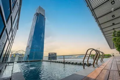 a swimming pool in front of a tall building at #TRX KL #2BR #4Pax #2Gbps #Netflix #Hotel Feel in Kuala Lumpur