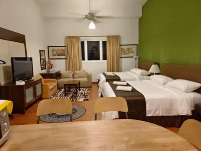 a hotel room with two beds and a television at Maytower Apartment Studio Kuala Lumpur in Kuala Lumpur