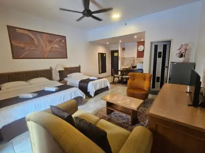 a hotel room with two beds and a living room at Maytower Apartment Studio Kuala Lumpur in Kuala Lumpur
