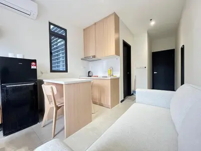 a kitchen and living room with a counter and a table at Arte Plus Ampang By Comfortcorner in Kuala Lumpur