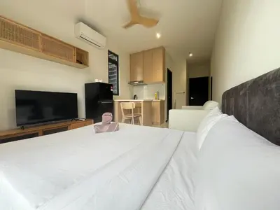 a bedroom with a large white bed with a flat screen tv at Arte Plus Ampang By Comfortcorner in Kuala Lumpur