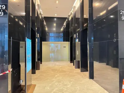 a hallway with glass walls in a building at The Platinum KLCC By Homestay in Kuala Lumpur
