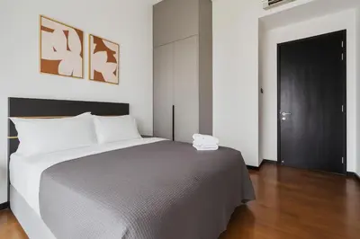 a bedroom with a bed and a black door at Opus by Soulasia in Kuala Lumpur